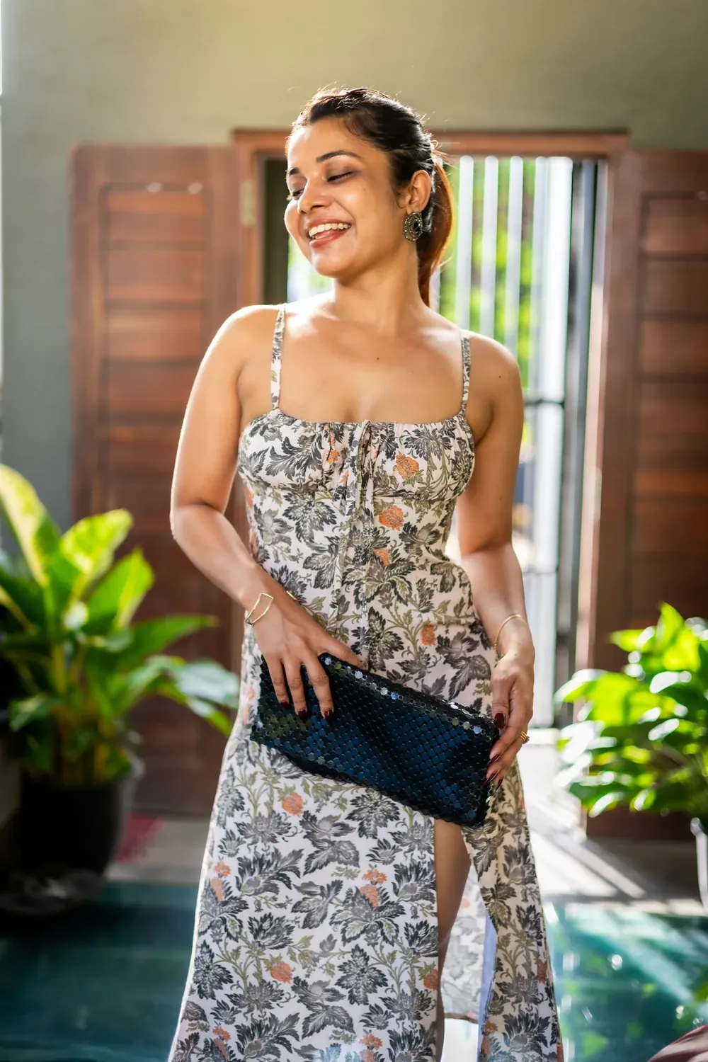 Model in a dress beside a window in soft natural light, photographed for the clothing brand MOA