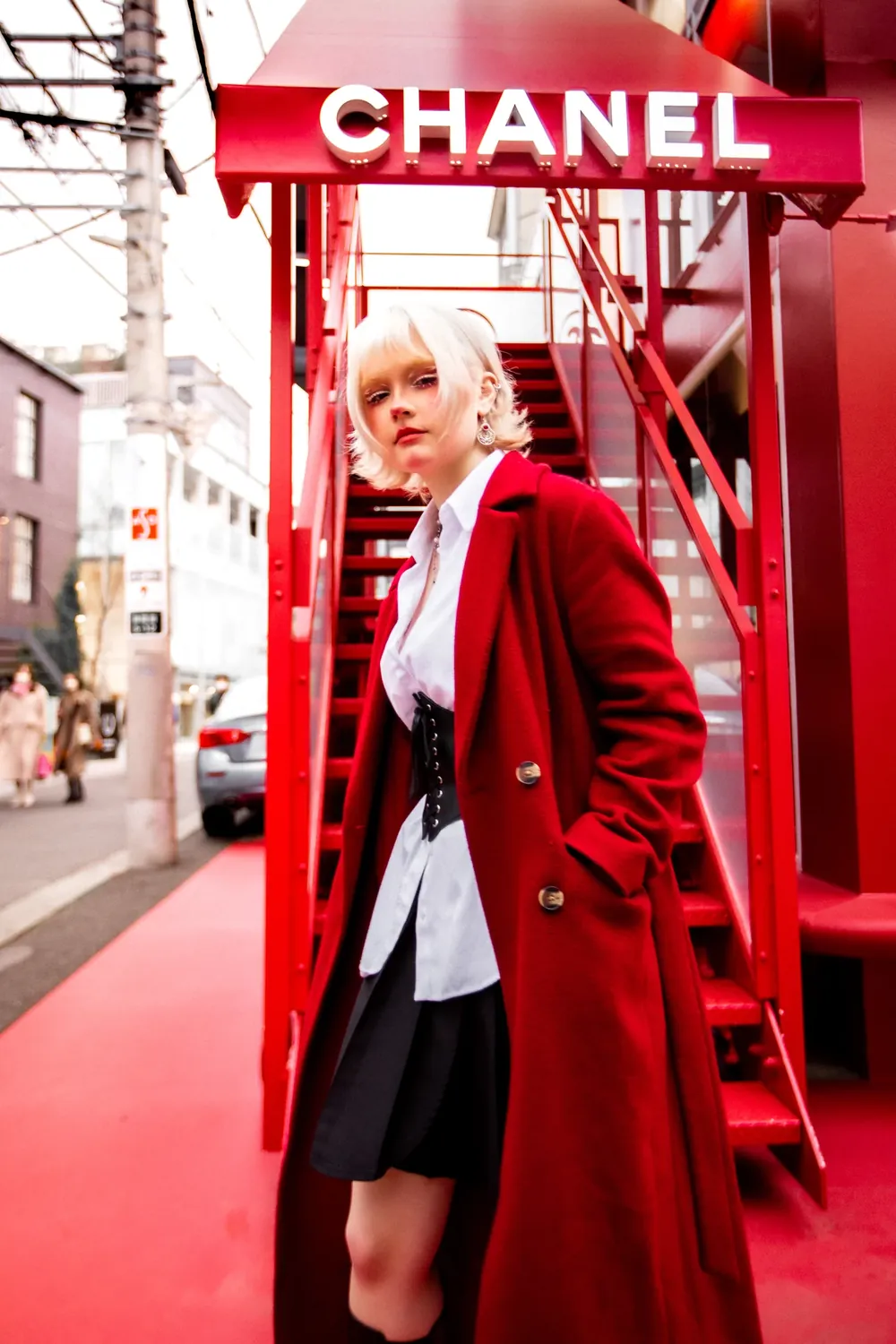 Model in a red coat on a Tokyo shopping street, fashion portrait from the Tokyo story