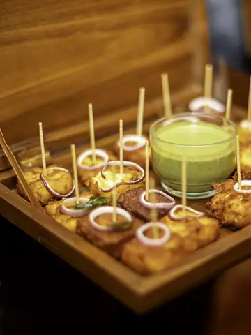 Tray of Indian sweets with a candle at a wedding celebration