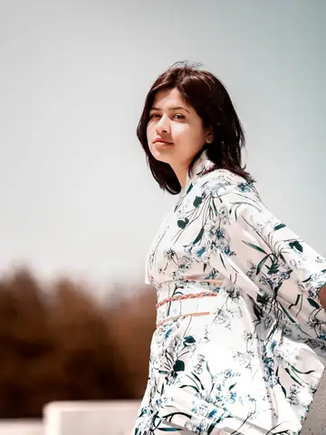 Woman in a floral kimono standing outdoors