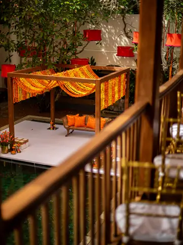 Decorated courtyard with lanterns seen from a wooden staircase