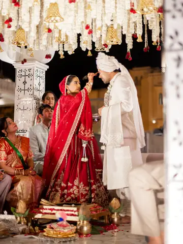 Wedding ceremony moment beneath hanging white floral strands