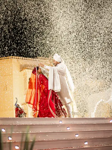 Bride and groom showered with white confetti during their wedding ceremony