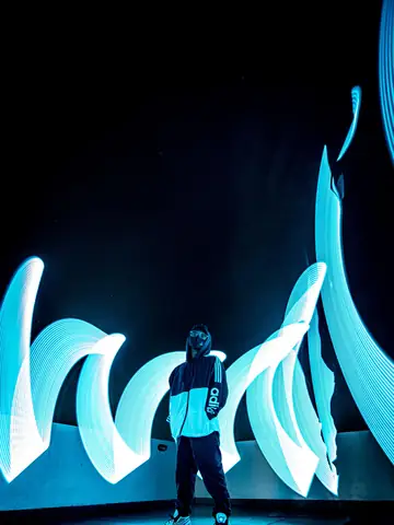 Figure surrounded by sculptural blue light