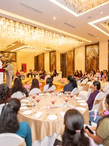 Guests seated at round tables in a hotel ballroom