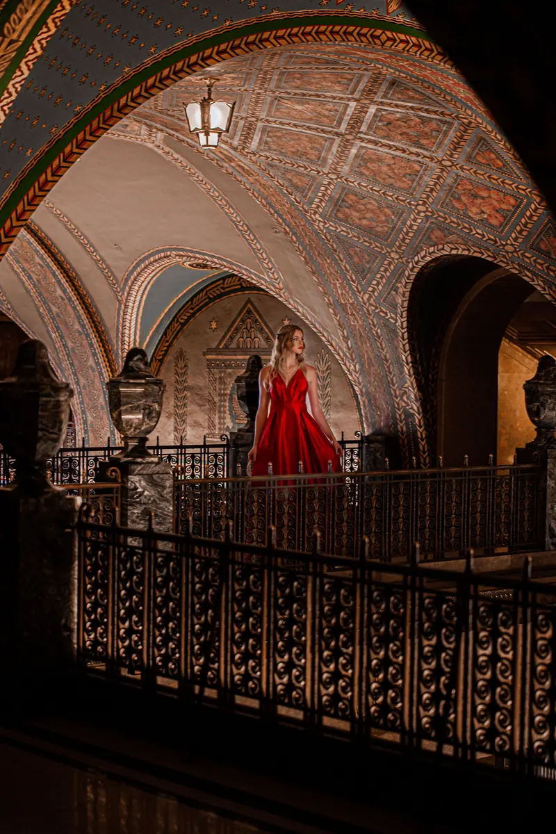 Woman in a dramatic red gown in an ornate interior