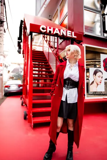 Ylva Brandt in a red coat under a red Chanel storefront