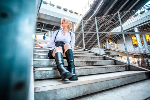 Ylva Brandt seated on wide concrete city steps beneath an overpass